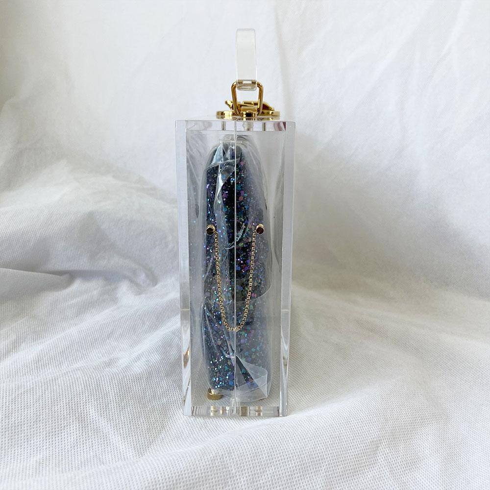 Charlotte Olympia clear acrylic box clutch with blue glittery zip pouch
