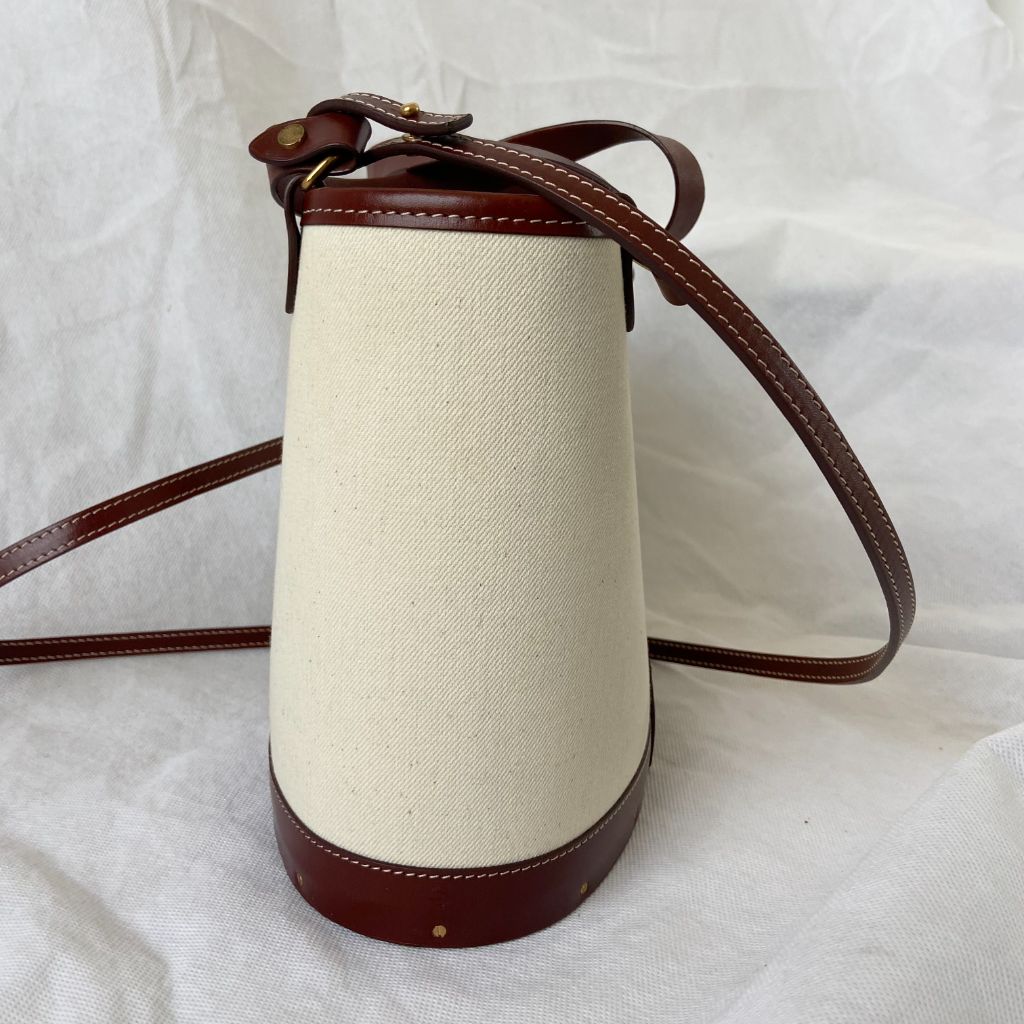 The Row beige canvas and leather bucket bag