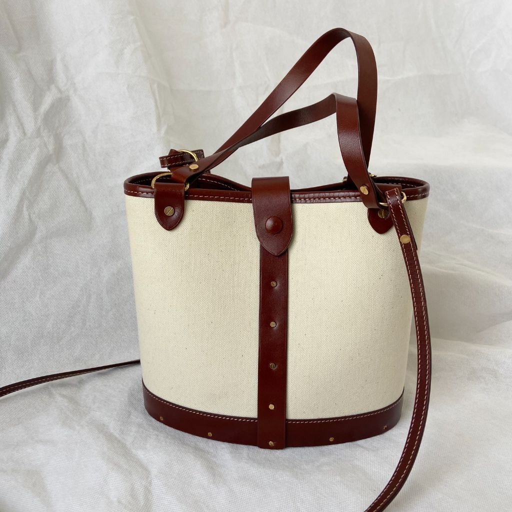 The Row beige canvas and leather bucket bag
